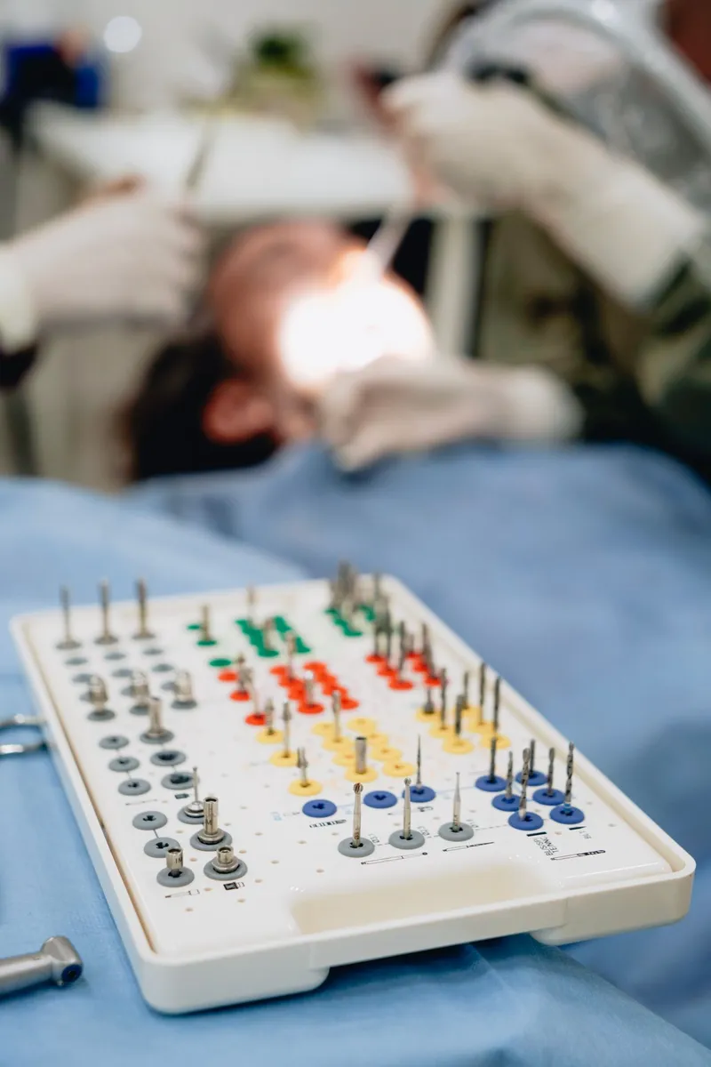 Dental implant procedure kit with titanium components, drills, and abutments — the surgical tools used at safe, accredited dental implant clinics in Turkey